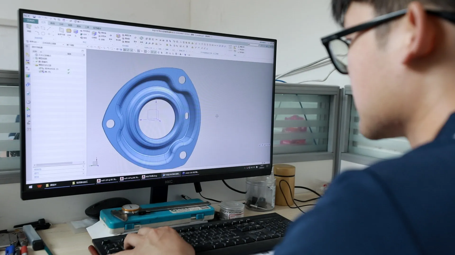 ROXARA engineer reviewing a manufactured-part model in CAD