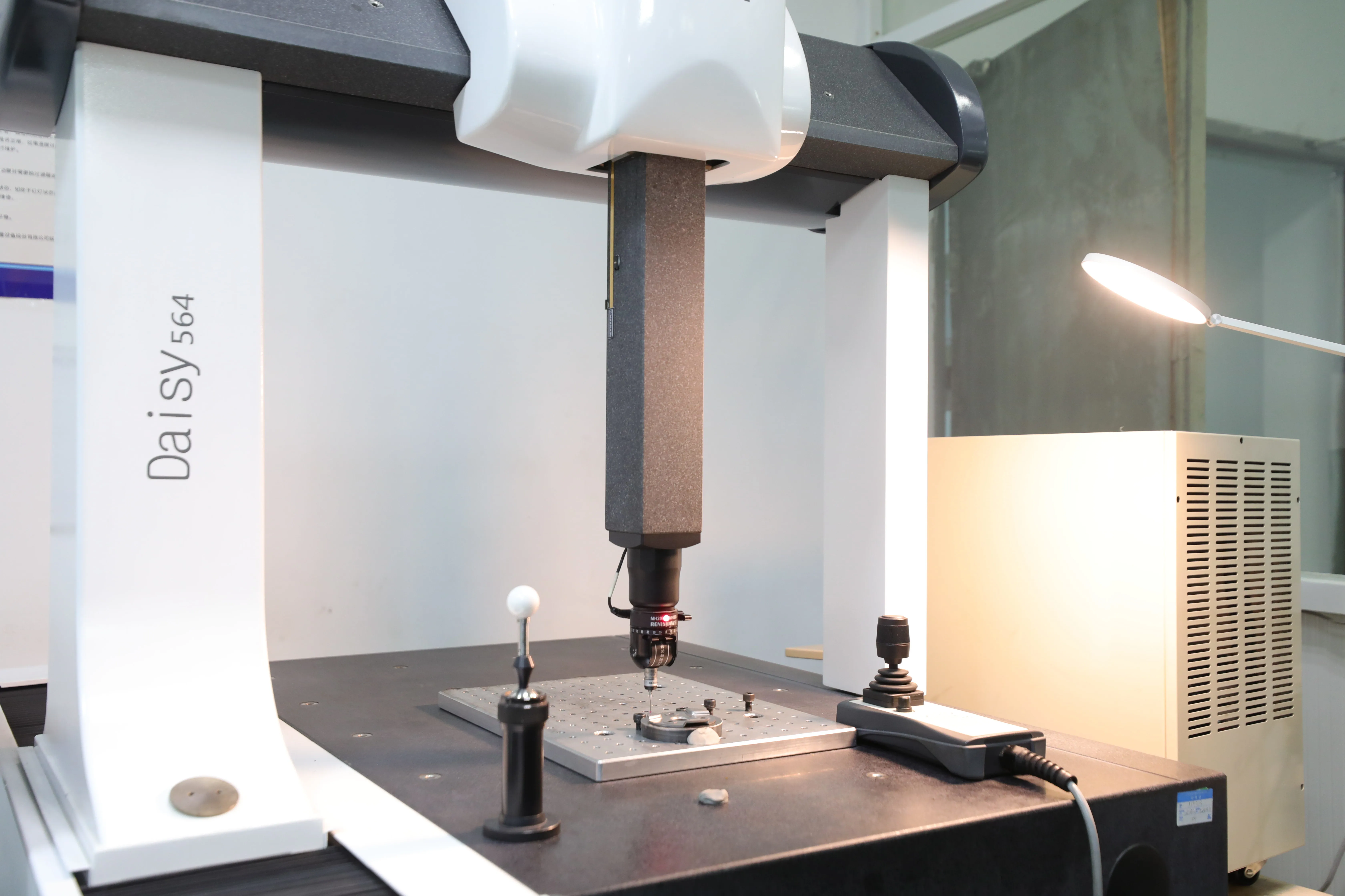 Coordinate measuring machine probe inspecting a manufactured component